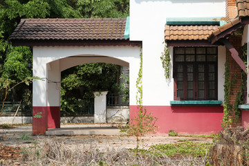 Front yard of old concrete house.