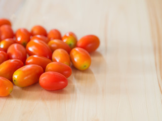 Cherry Tomatoes on pine wooden table.