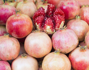 Ripe Pomegranates. Time of harvest. Healthy food. Agricultural concept. Bright fruit background  (Selective focus)