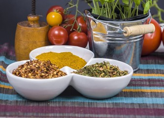 tomatoes, basil and spices on dark grunge backdrop