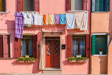 Fototapeta na wymiar Multi-colored houses and clothing line on the island Burano, Ve