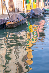 Fototapeta na wymiar multi-colored houses reflected in the canals on the island Bura