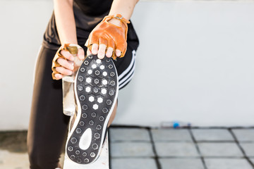 Happy asian young woman stretching before running city outdoors