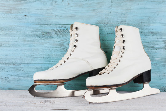 Vintage ice skates for figure skating on turquoise background