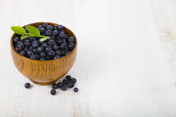 Blueberries in a wooden bowl on a  table