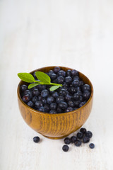 Blueberries in a wooden bowl on a  table