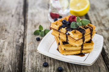 Belgian waffles with raspberries, blueberries and mint, covered