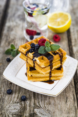 Belgian waffles with raspberries, blueberries and mint, covered