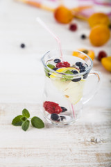 Homemade lemonade with fresh berries on a wooden table.Cocktail