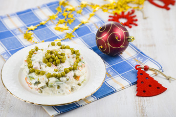 Olivier salad on a table with Christmas decorations. Christmas C