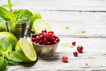 Christmas decorations in the composition of natural wicker basket on dark wooden background from shretskih nuts, pomegranate, red  tree balls, fir branches and snow
