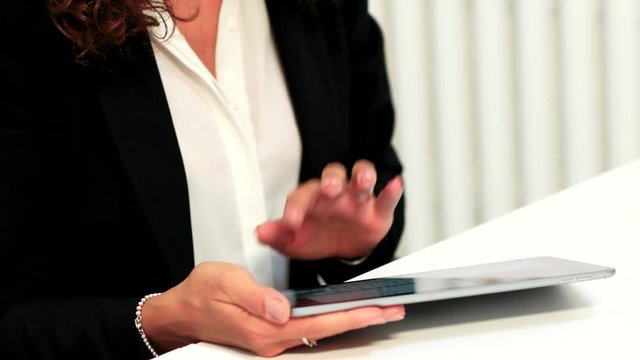 Woman using a tablet in her office. 