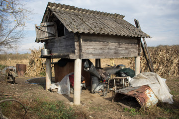 Wood shack junkyard in the field 