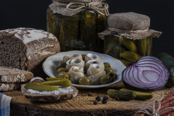 Herrings Pickles. Salted Cucumbers still-life with dark bread