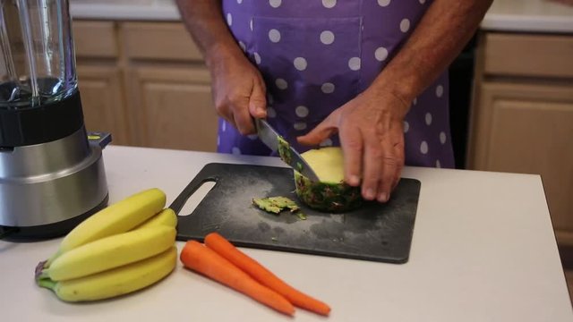 Healthy living: Man cutting row organic pineapple for smoothie