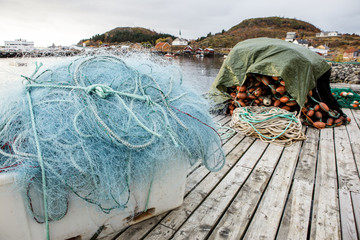 Fototapeta na wymiar Many fishing nets and floats, stacked on a wooden dock. Fisheries, fishing. Fishing industry. Fishing ship, boat. Background.