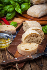 Sliced ciabatta bread on cutting board.