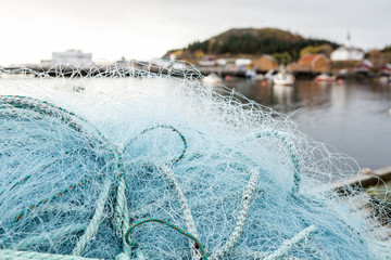 Many fishing nets and floats, stacked on a wooden dock. Fisheries, fishing. Fishing industry.   Background.