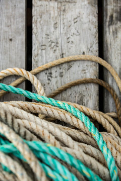 Rope lies on a wooden dock. Background.