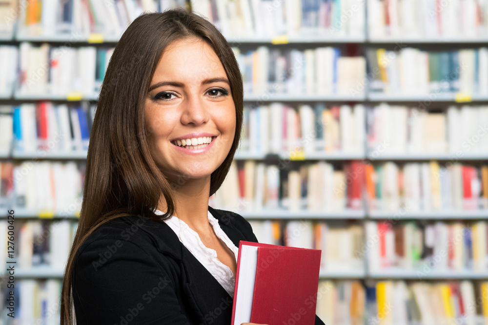 Wall mural Woman holding a book