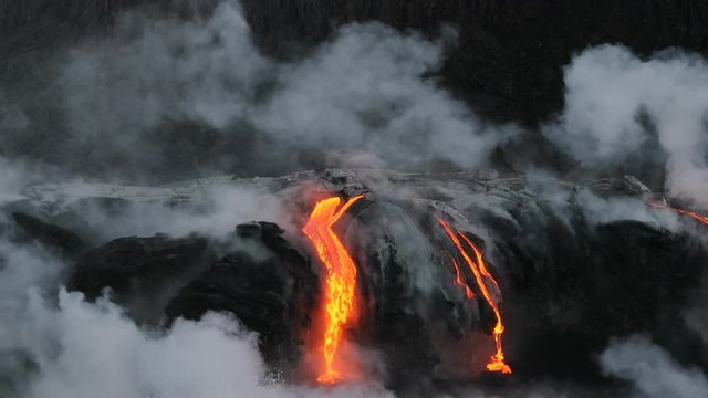 Lava ocean - flowing lava reaching ocean on Big Island, Hawaii. Lava stream seen from the water flowing from Kilauea volcano near Hawaii volcanoes national park, USA. 59.94 FPS, Steadicam. Year 2016.