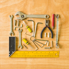 Set of different work tools on wooden table background.