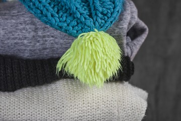 Knitting clothes on wooden background