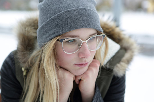 Portrait of thinking girl in glasses