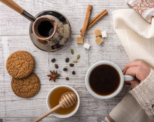 woman drinking coffee with cookies closeup