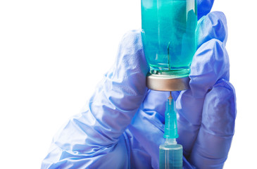 Hand in medical glove holding vial with medicine in blue