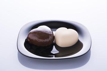 Two heart-shaped cakes in white and black