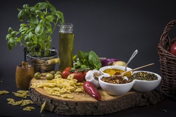 tomatoes, basil and spices on dark grunge backdrop