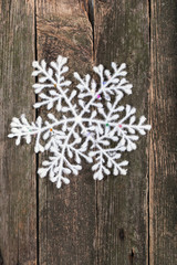 White snowflake on a wall from old boards