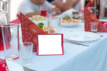 Naklejka na ściany i meble Greetings card lies on the covering of the festive wedding table