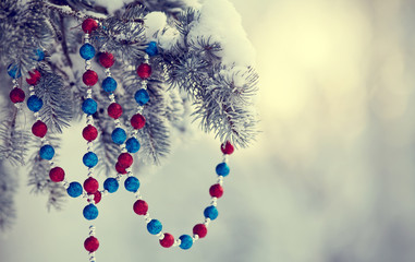 Fir-tree in snow with Christmas-tree decoration