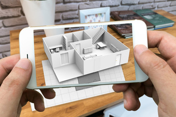 Augmented reality marketing concept for architecture. Hand holding smart phone using AR application to simulate 3d popup interactive room maps to life. 3d rendering
