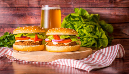Hamburger and beer on wooden board