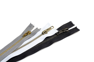 Metallic jeans zippers on white background