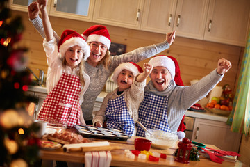 happy family baking cookies on Christmas. - obrazy, fototapety, plakaty