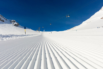 Newly groomed ski slope on a sunny day