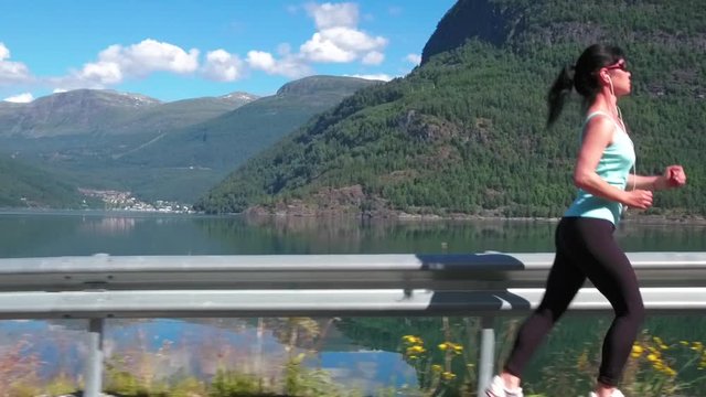 Woman jogging outdoors. Norwegian fjord.