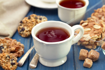 cup of tea with cookies and sugar
