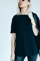 Fashion model in leather clothing and t-shirt