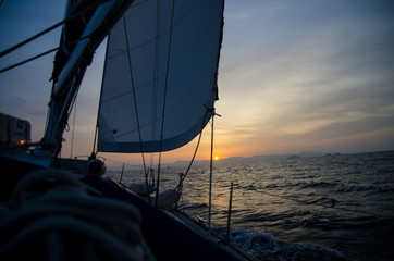 Sunset on a yacht under sails with genoa