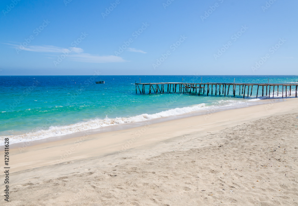 Wall mural Long simple wooden jetty leading into turquoise blue ocean in Angola