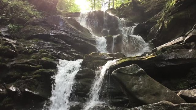 Small waterfall Shypit in Ukrainian mountains. Slowmotion shot.