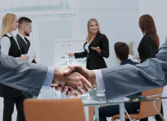 businessmen shaking hands after signing a lucrative financial co