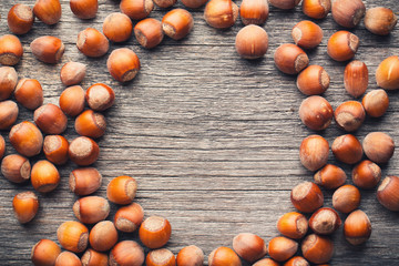 Hazelnuts on wood table with copyspace