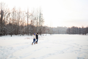 Winter vacation in christmas day, cold xmas weather with white snow and lovely couple