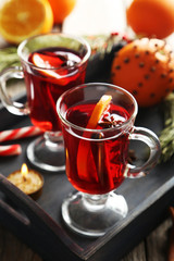 Mulled wine in glass on grey wooden table